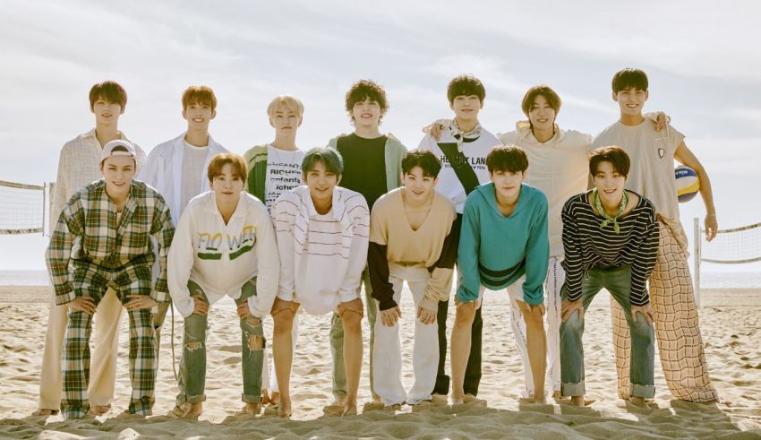 A group of boys posing for a picture on the beach.