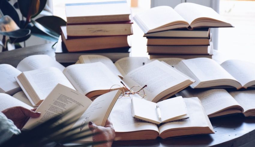 A person is reading a book on a table.
