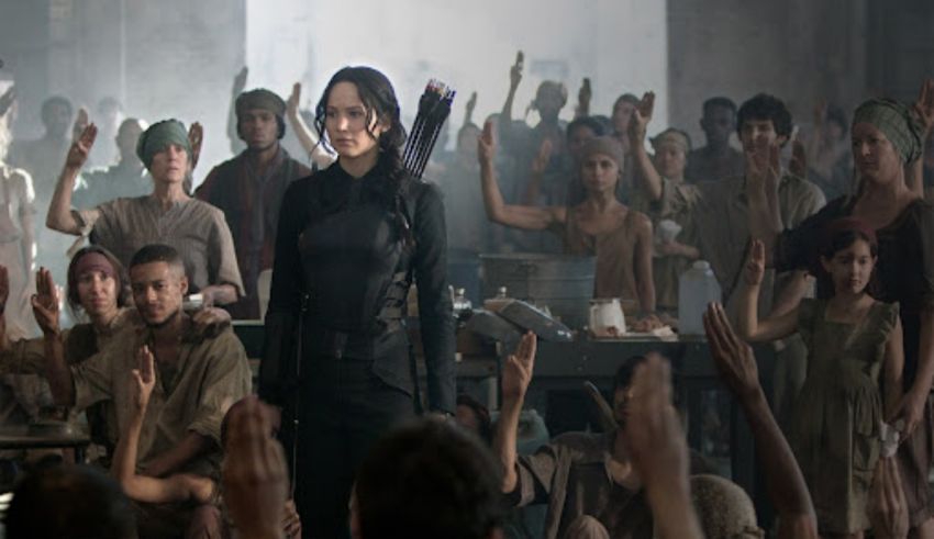 A woman is standing in front of a crowd of people.