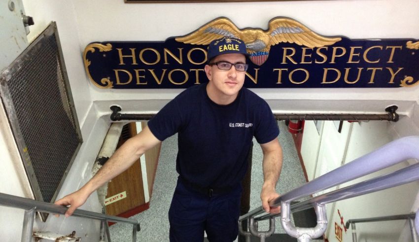 A man standing on stairs with a sign that says honor respect devotion to duty.