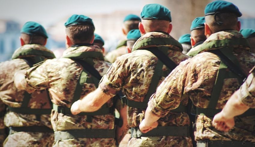 A group of soldiers wearing green uniforms.