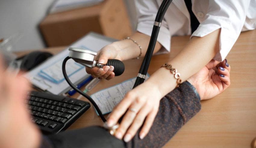 A doctor is taking a patient's blood pressure.