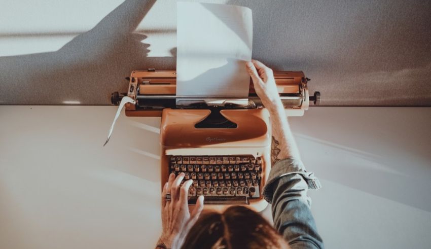 A woman writing on a typewriter.