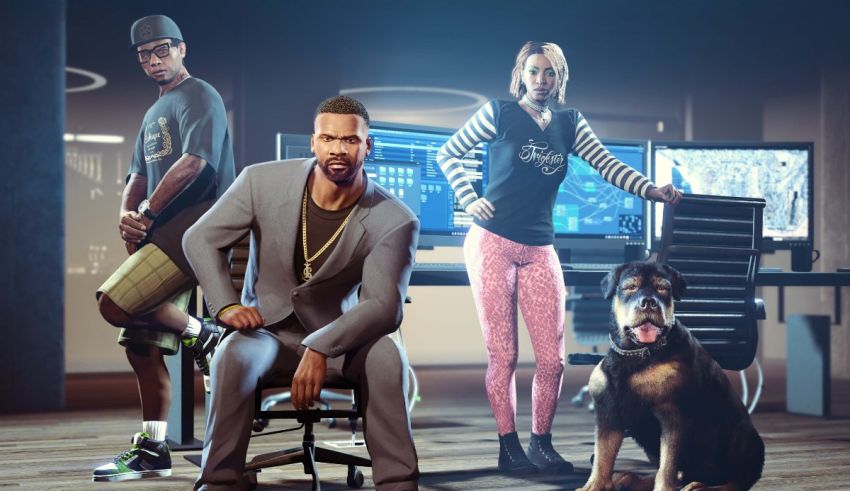 A group of people and a dog are standing in front of a desk.