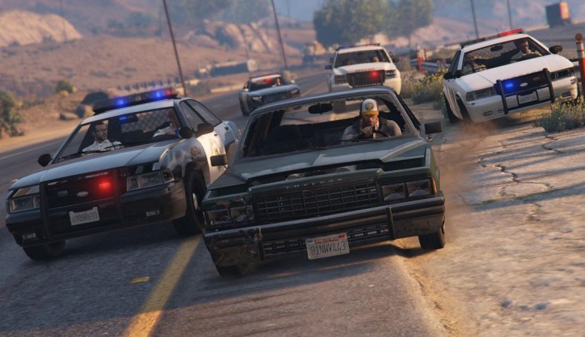A group of police cars driving down the road.