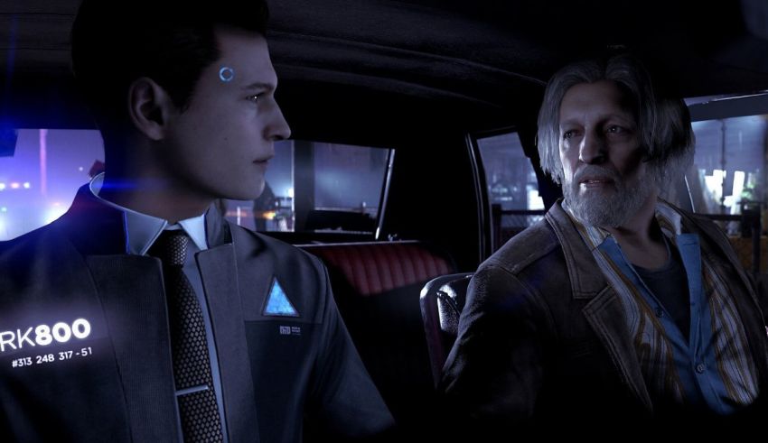 A man in a suit and tie is sitting in the back seat of a car.