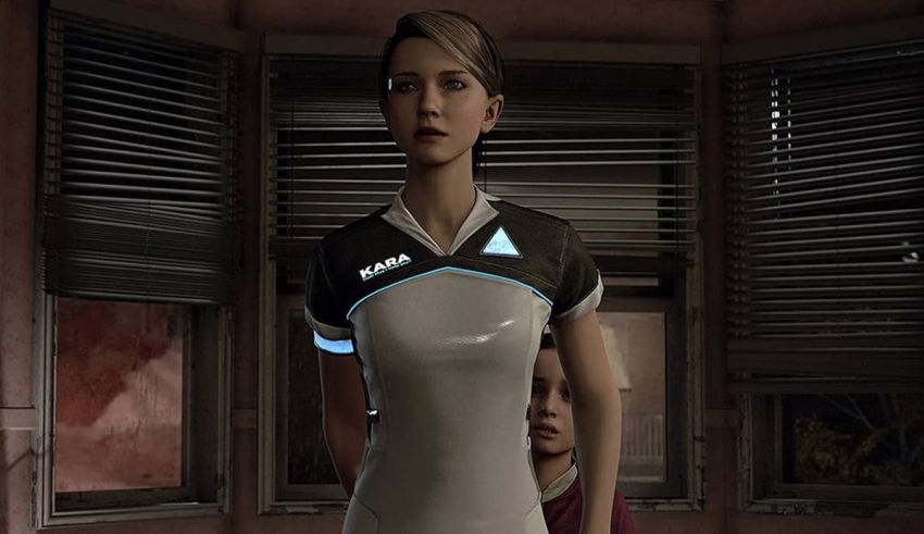 A woman in a white shirt is standing in front of a window.