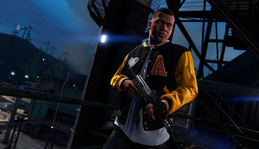 A man in a yellow jacket is holding a gun.