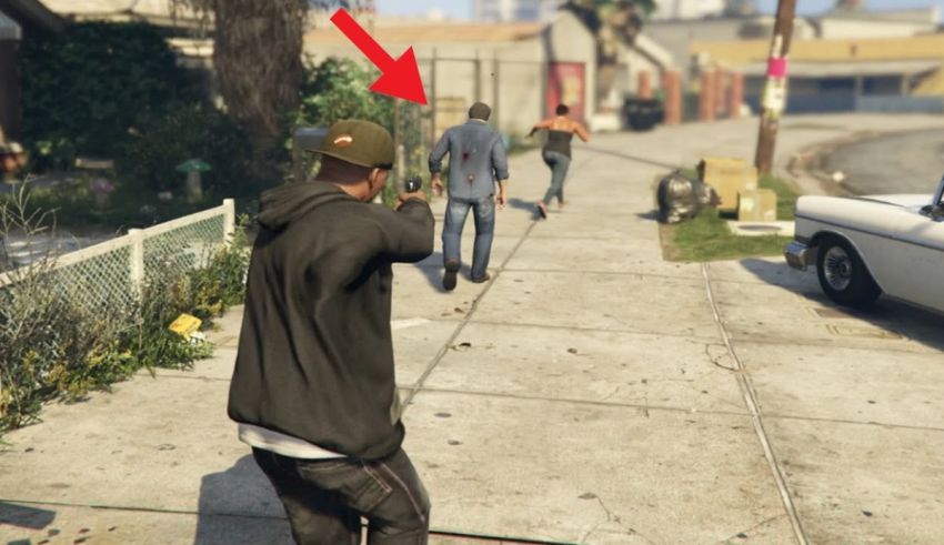 A man is walking down the street with a gun in his hand.