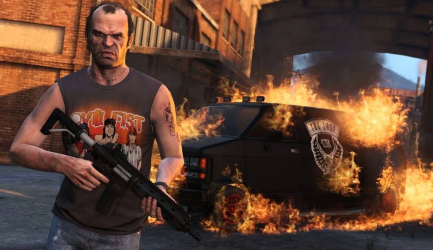 A man with a gun is standing in front of a fire.