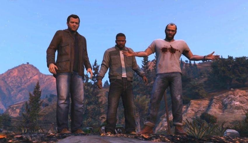 A group of people standing in front of a mountain.