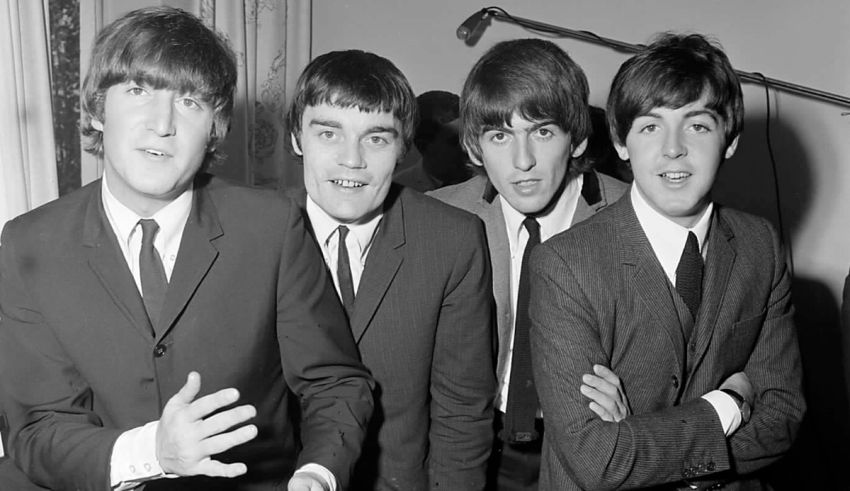 The beatles pose for a photo in a black and white photo.