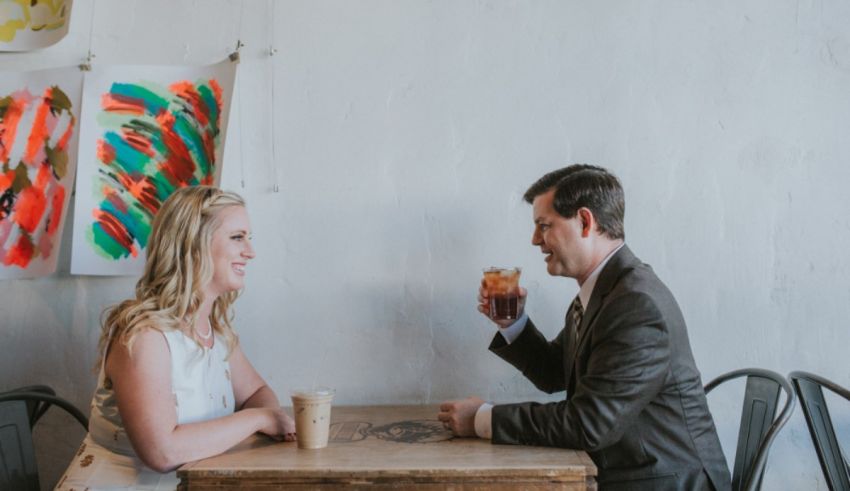 A man and woman sitting at a table together.