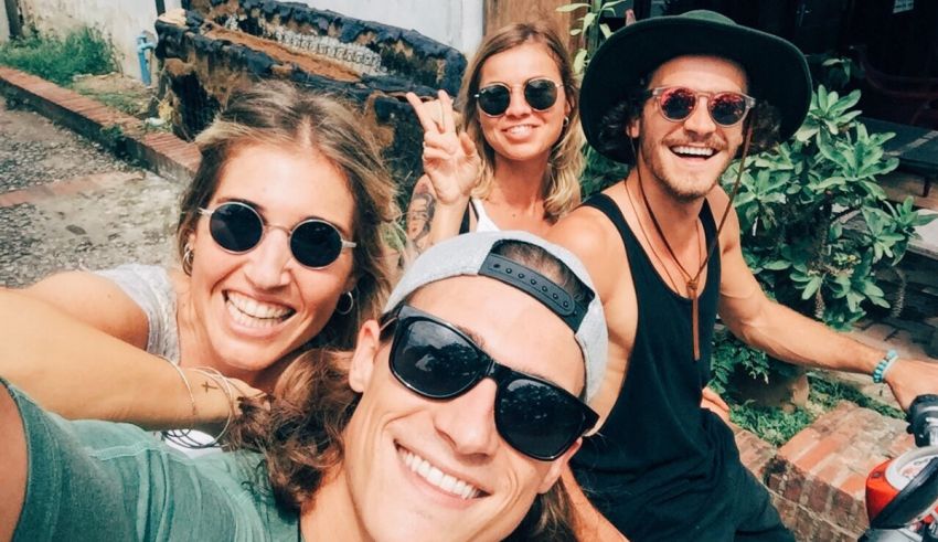 A group of people taking a selfie on a motorcycle.