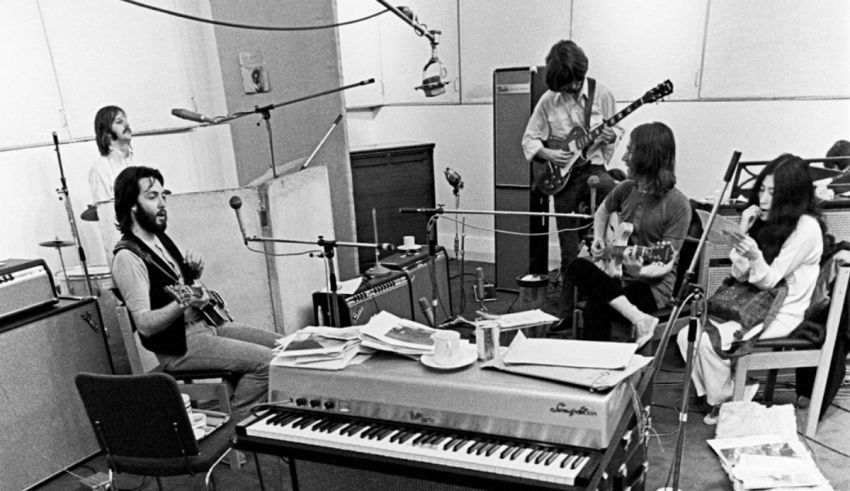 A black and white photo of a group of people in a recording studio.