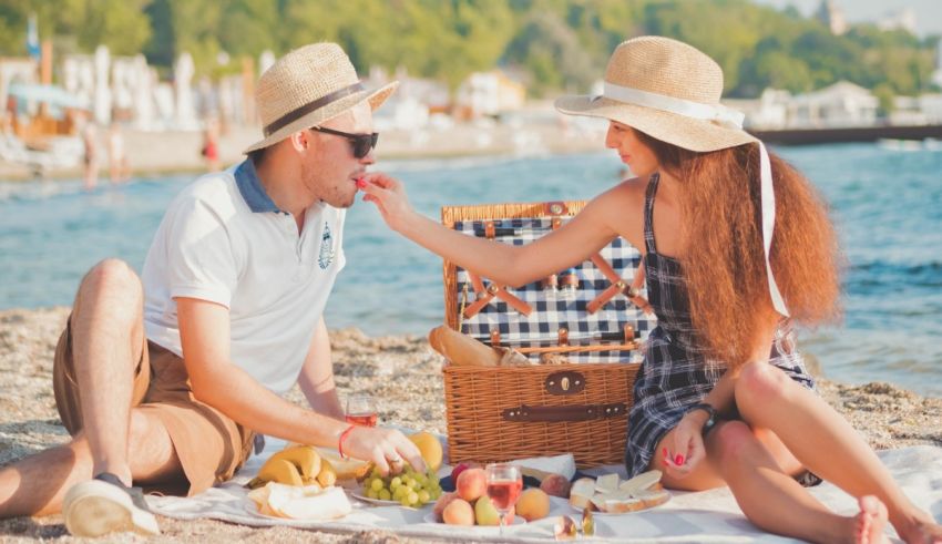 Young couple having a picnic on the beach.