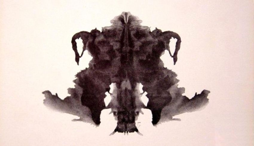 A black and white ink blot on a white background.