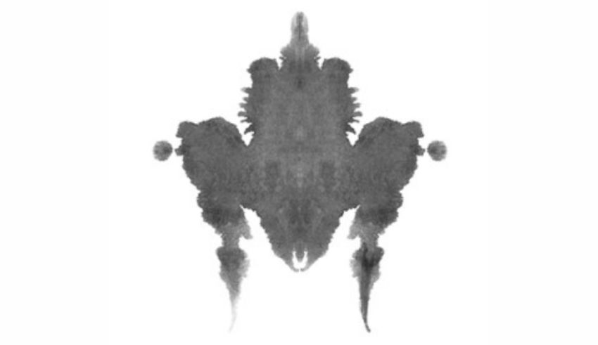 A black and white ink blot on a white background.