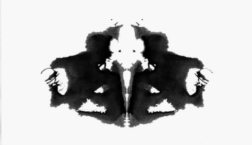 A black and white ink blot on a white background.