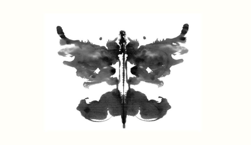 A black and white ink blot on a white background.
