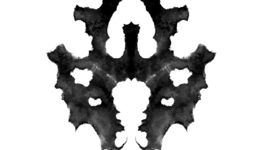 A black and white ink blot on a white background.