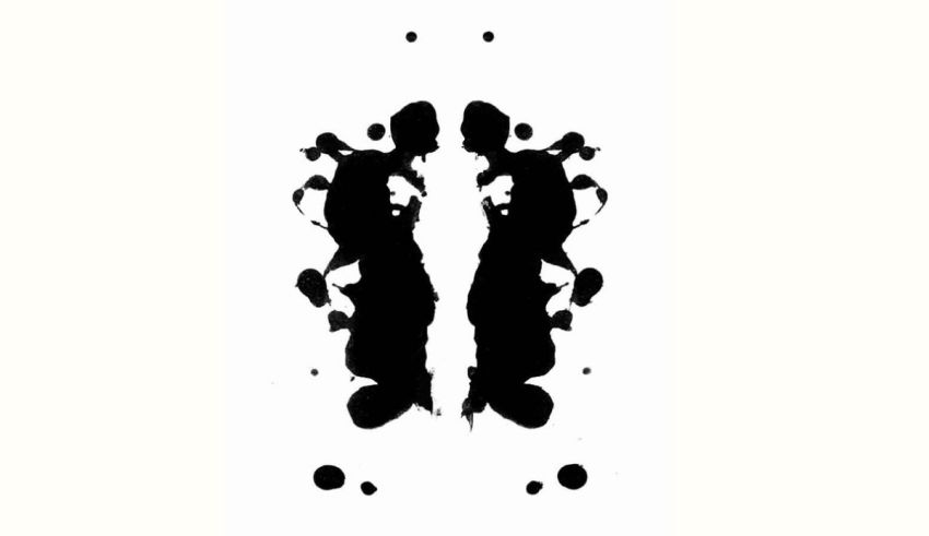 A black and white ink blot on a white background.