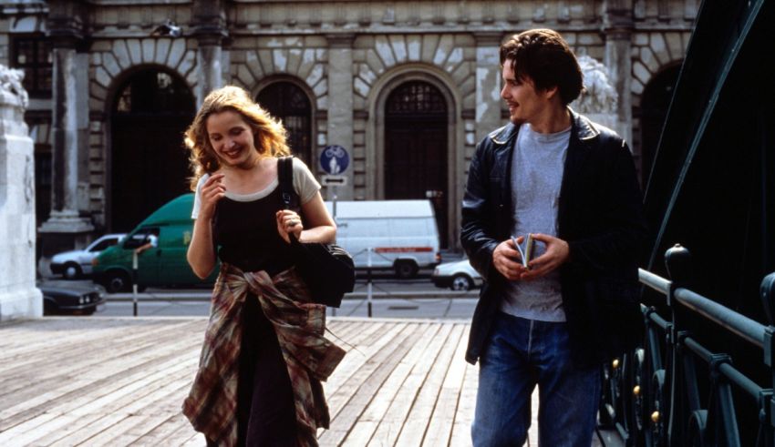 A man and a woman walking on a bridge.