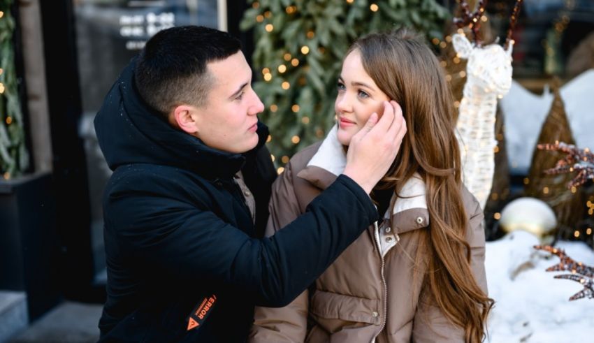 A man and a woman kissing in front of a store.