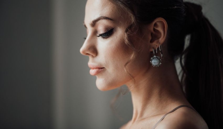 A woman with a ponytail and hoop earrings.