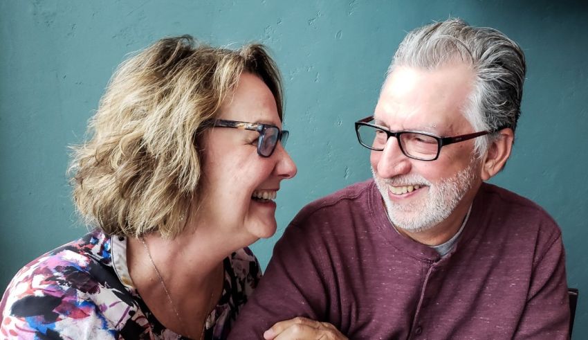 An older couple smiling at each other.