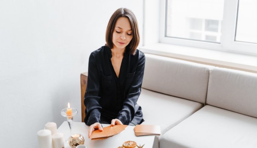 A woman is sitting on a couch reading a book.