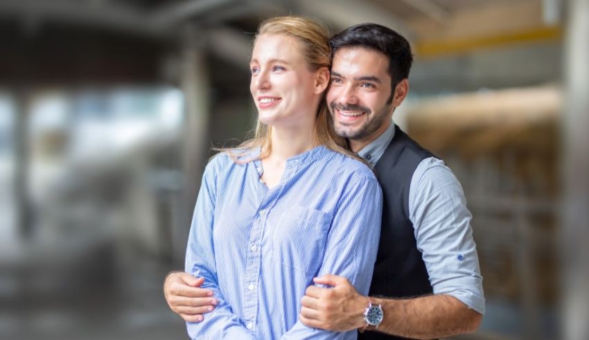 A man and woman hugging each other in a subway station.
