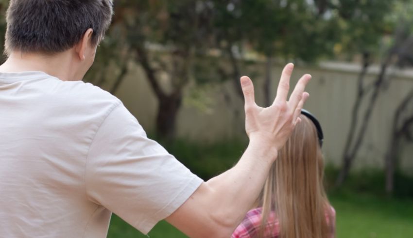 A man is holding up his hand to a girl.