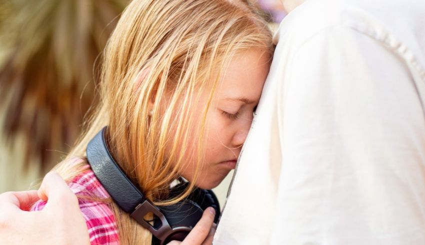 A girl is hugging a man while listening to music.