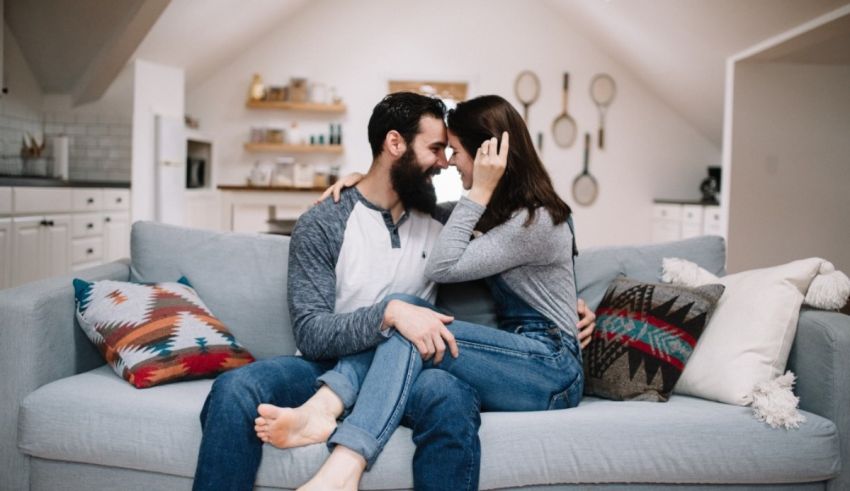 A couple sitting on a couch in their home.