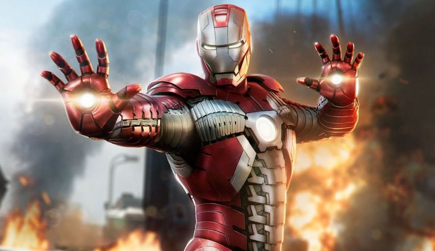 A man in an iron man suit is standing in front of a fire.