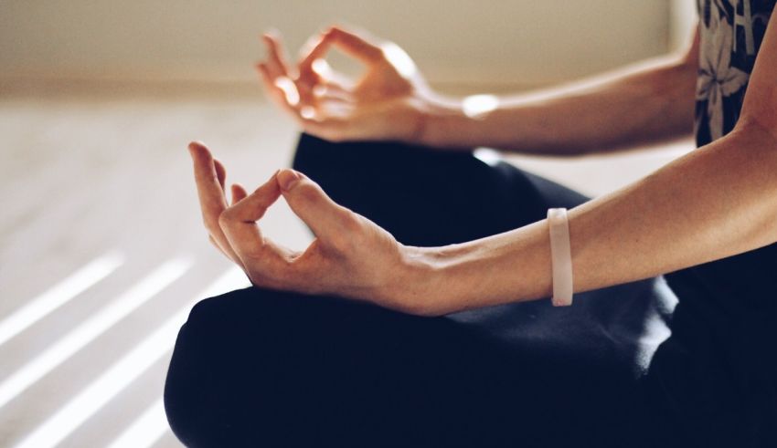 A person is meditating in a lotus position.