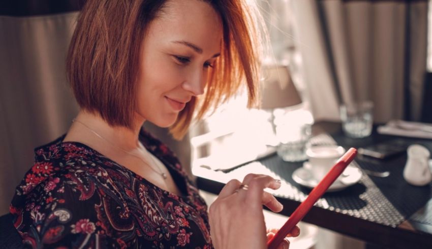 A woman using a tablet in a restaurant.