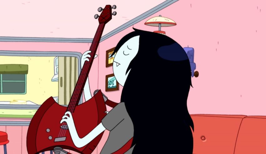 A girl with long hair playing a guitar in a room.