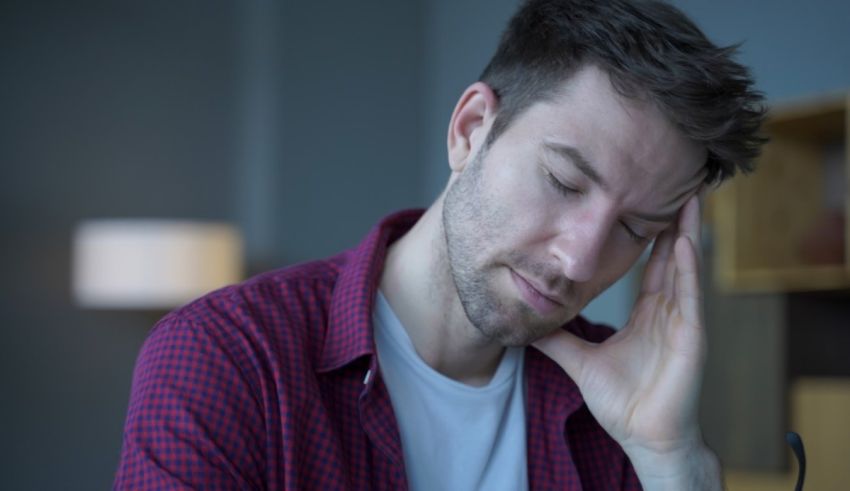 A man with his hand on his head.