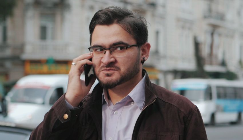 A man talking on a cell phone in a city.