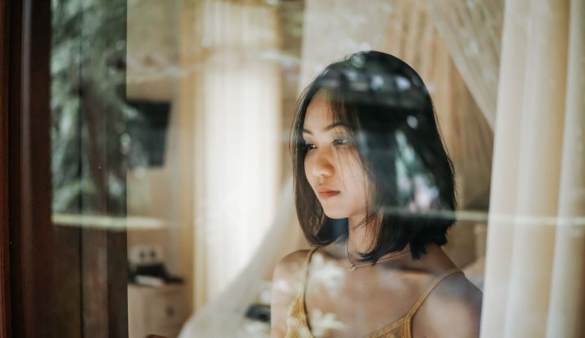 A young woman looking out of a window.