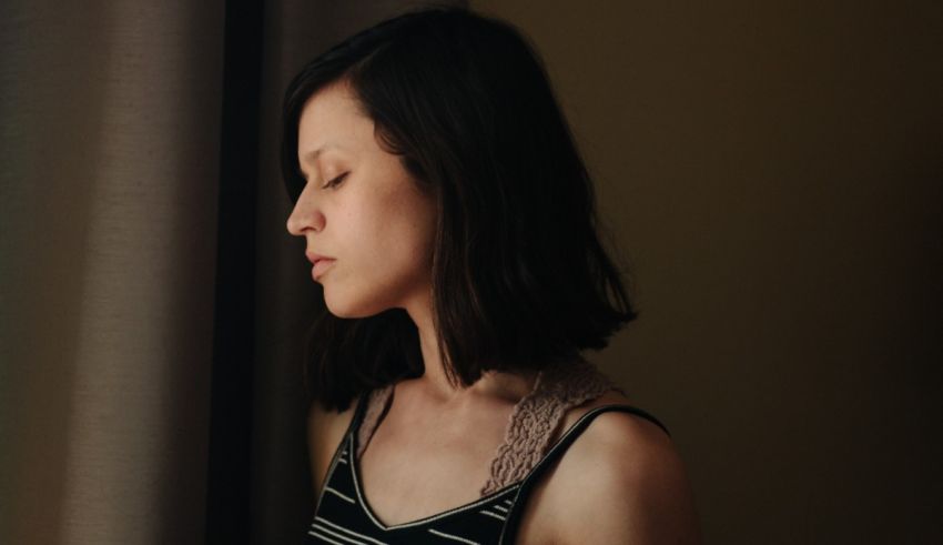 A woman in a striped top looking out the window.