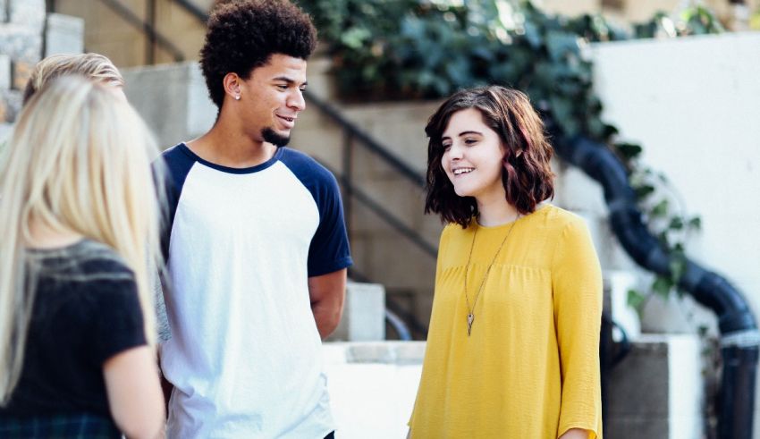 A group of young people talking to each other.