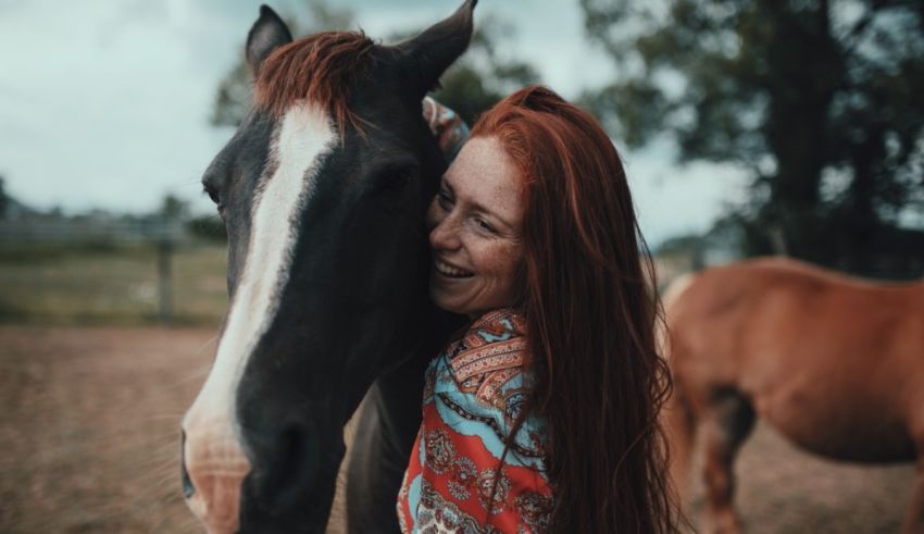 A woman with red hair is hugging a horse.