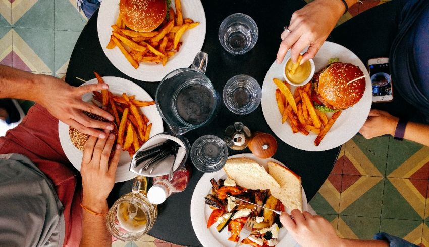 A group of people sitting around a table eating food.