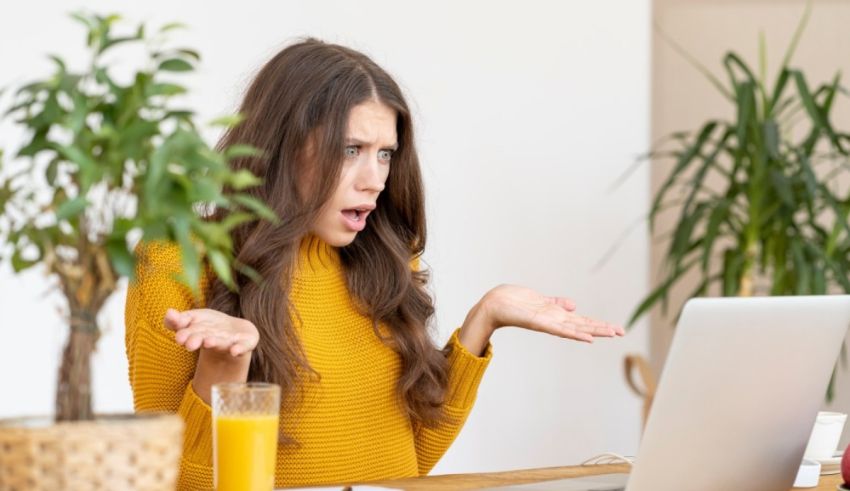 A woman is sitting in front of a laptop.