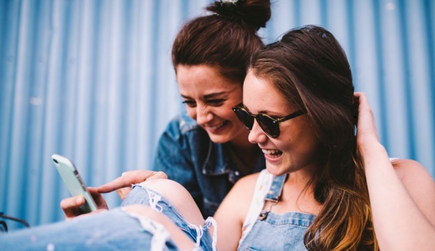 Two women looking at a cell phone.