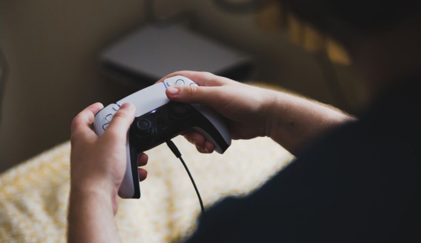 A person playing a video game on a bed.