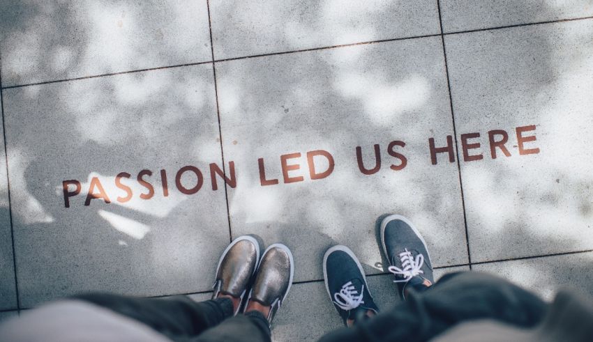 Two people standing next to a sign that says passion led us here.